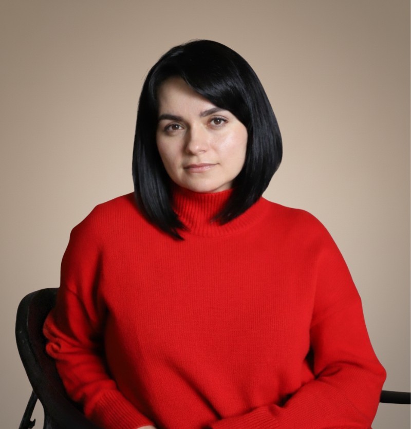 woman in brown coat using macbook air