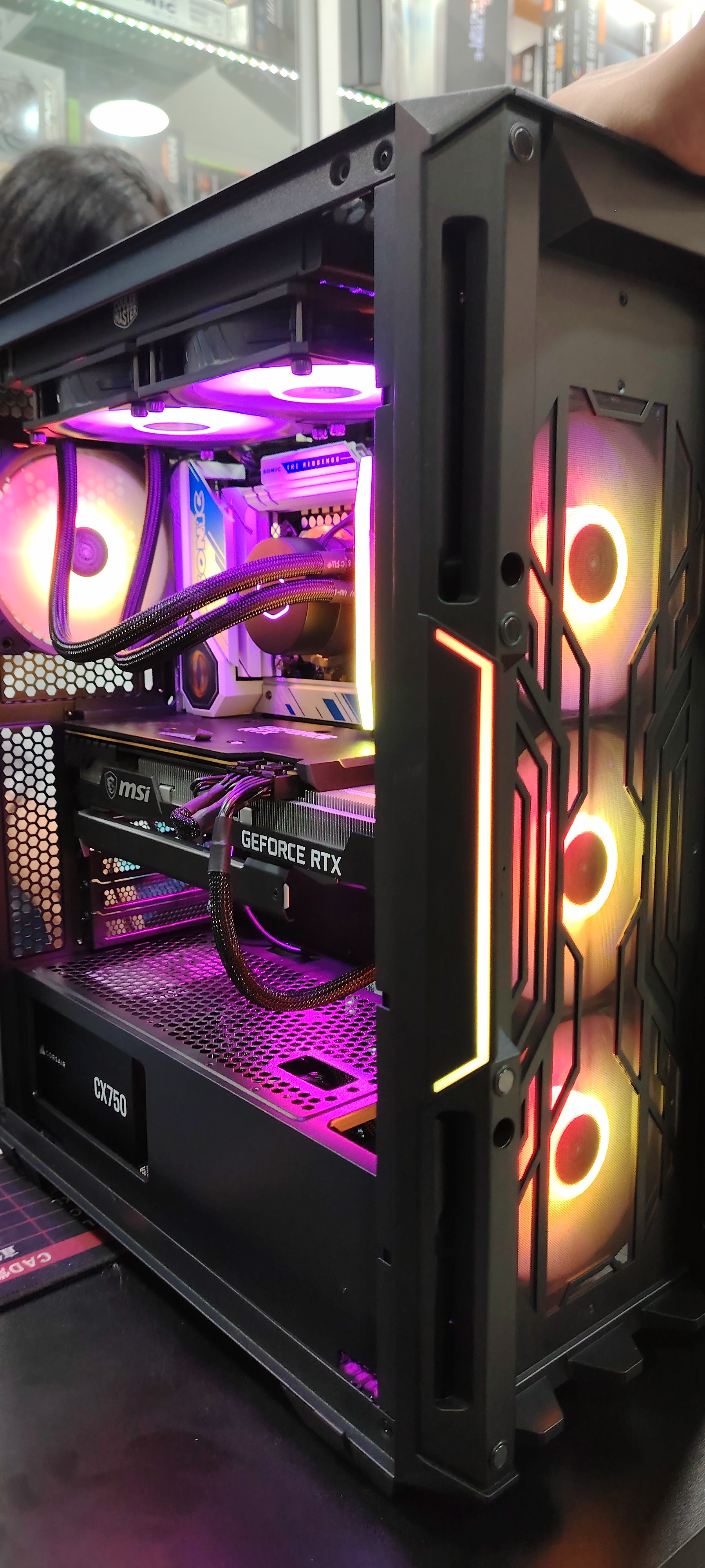 Angled view of a black athletic sneaker lying on its side, showcasing its textured, high-traction sole design against a neutral background.