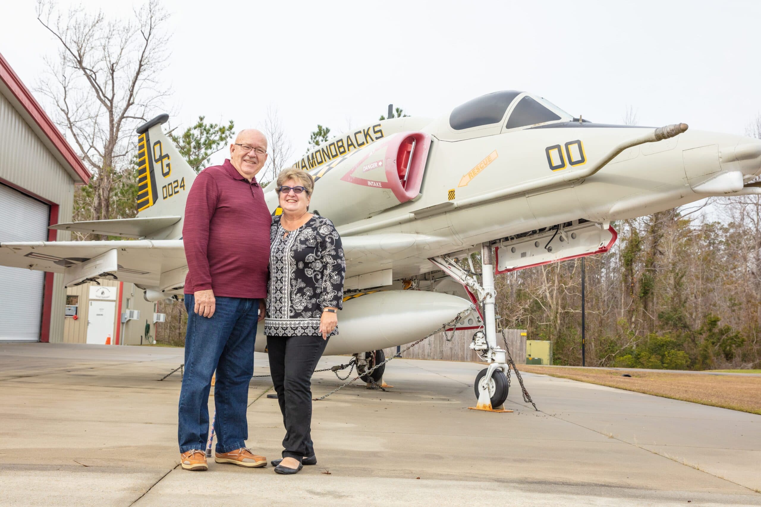 Couple Standing in front of a jet Stonebridge Dental Havelock