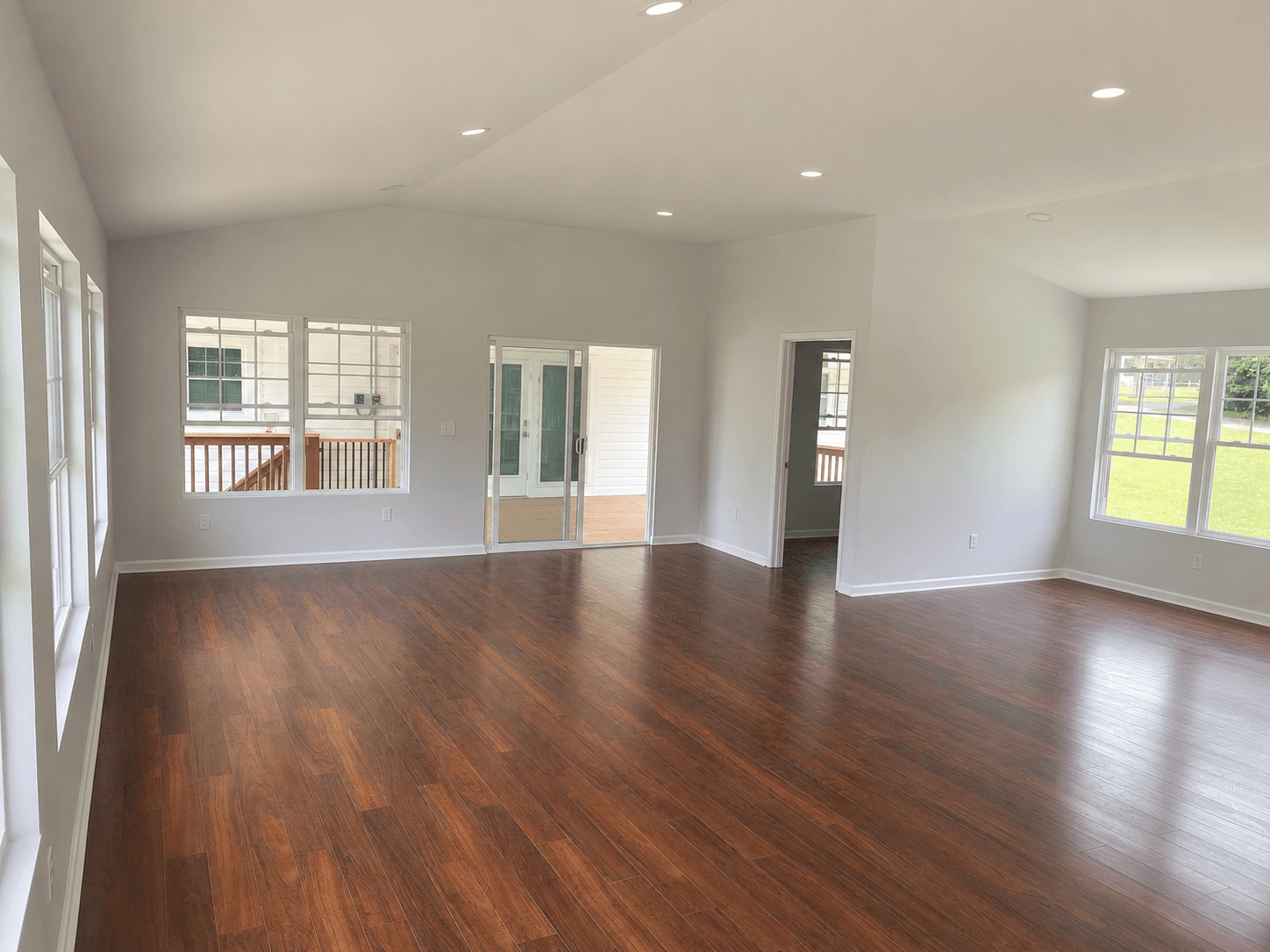 Interior view of a completed home addition showing an extra room and door leading to the covered porch area in Mount Airy NC.