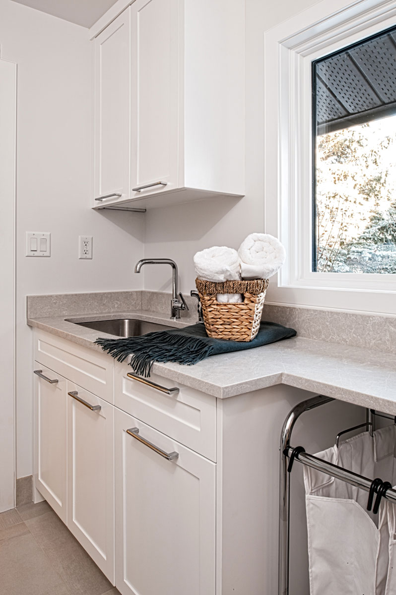 Image of Laundry room design with sink, cabinets, and countertop featuring KHD Homes layout and interior design expertise.