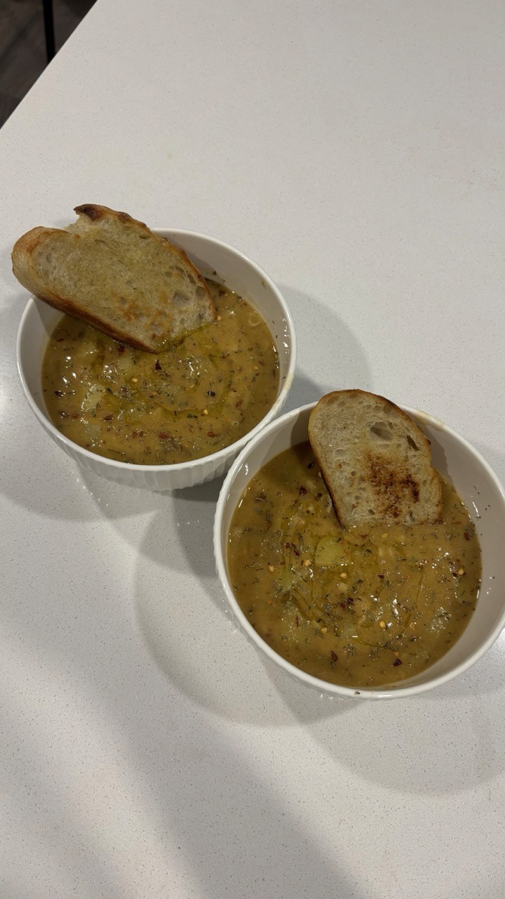 Two bowls of hearty vegan chickpea garlic soup with toasted bread – cozy high fiber lentil soup recipe Wellness by Suhey