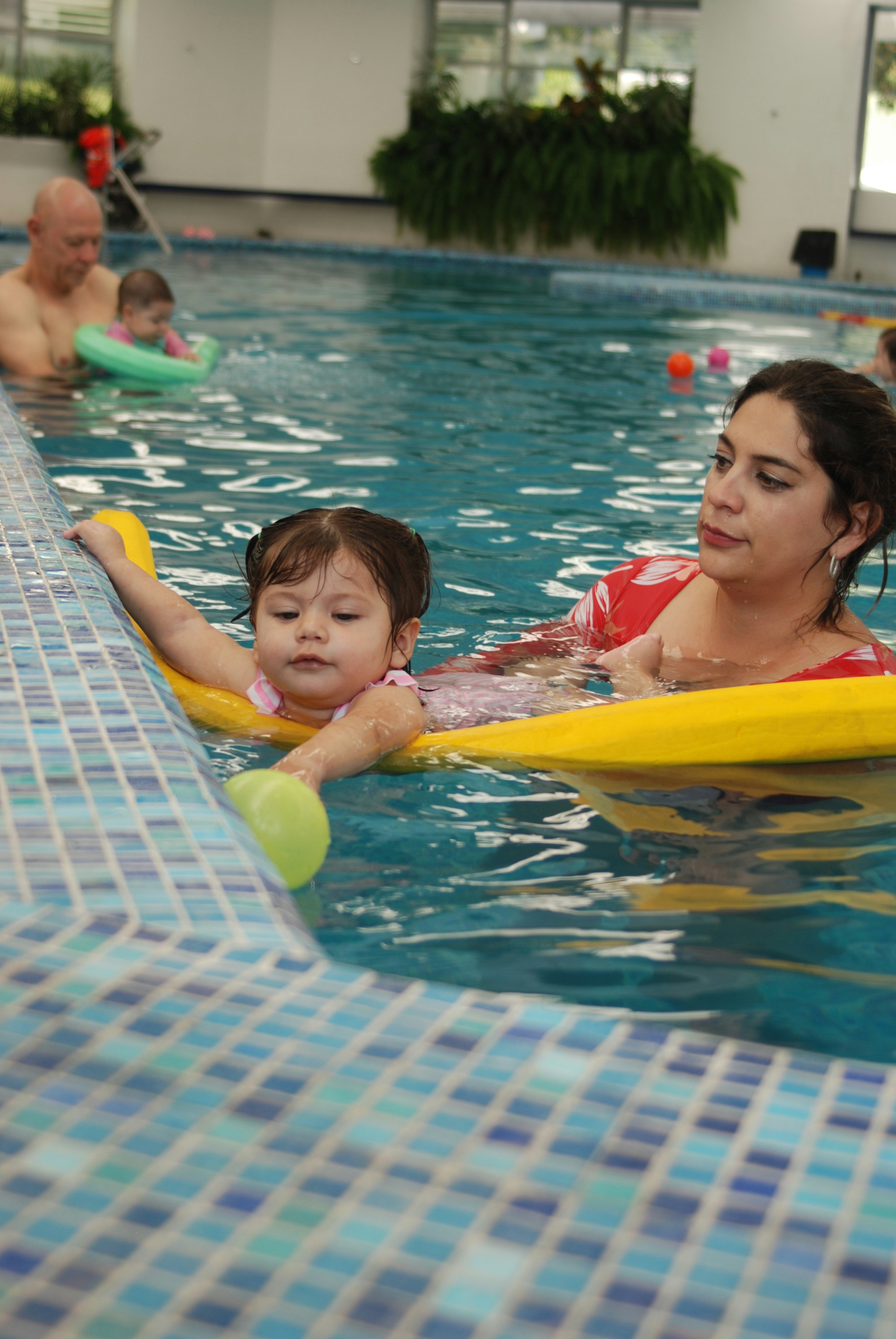 A woman and a child in a swimming pool