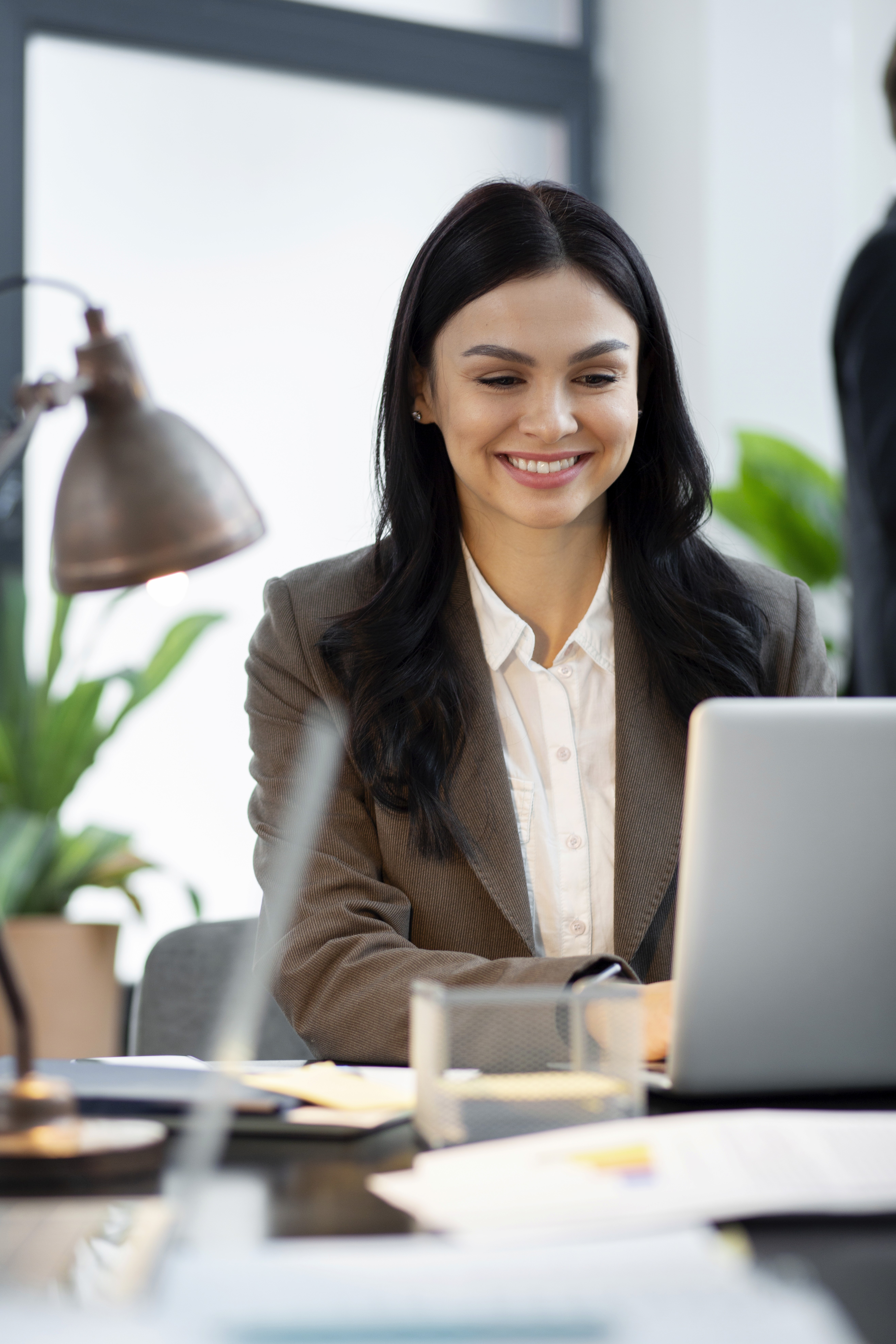 two ladies looking at a laptop and smiling