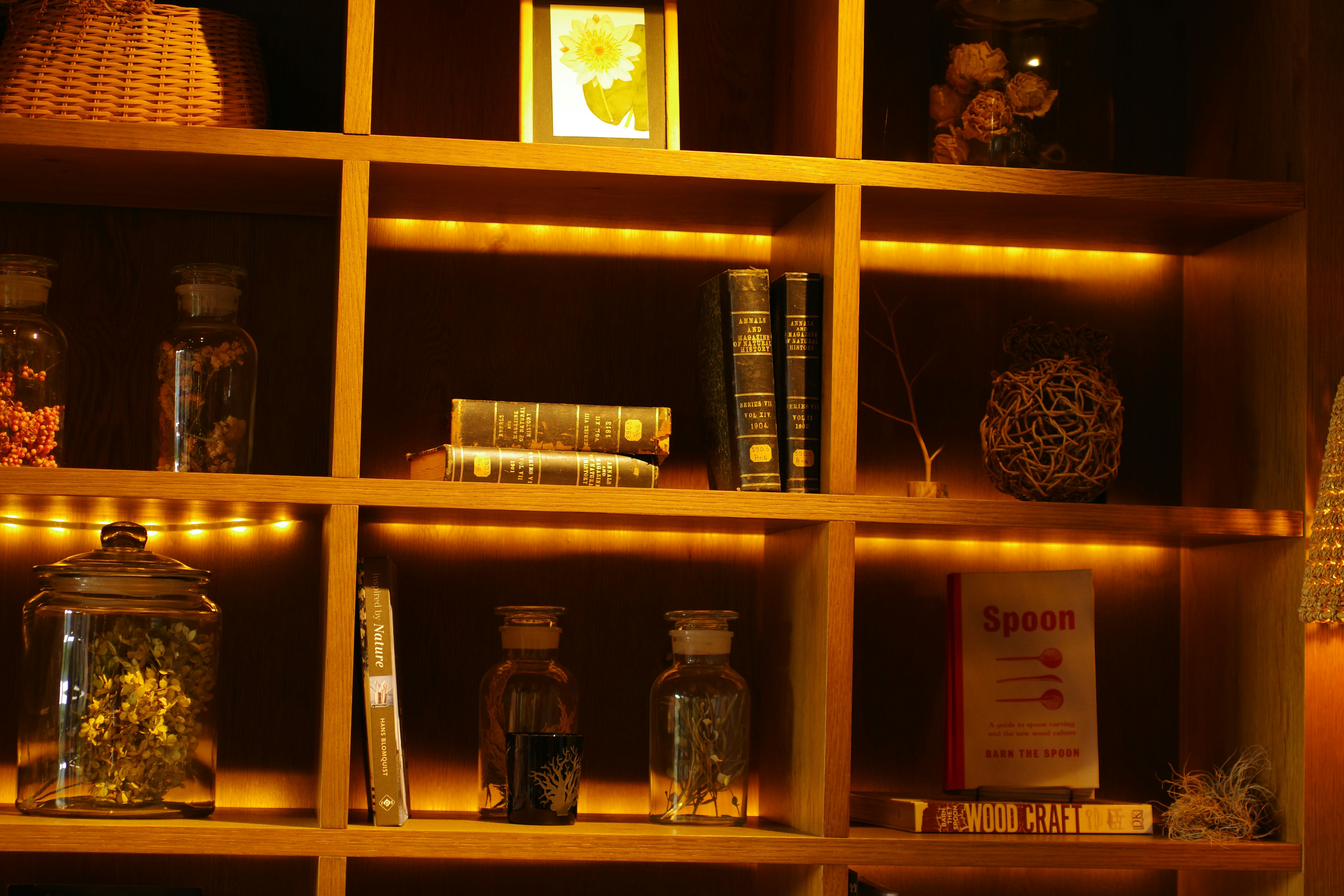 A bookshelf filled with lots of books next to a lamp