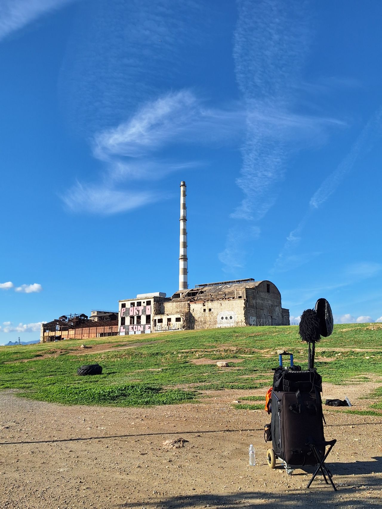 Location sound recording setup with boom microphone and sound cart on an exterior shoot in Greece
