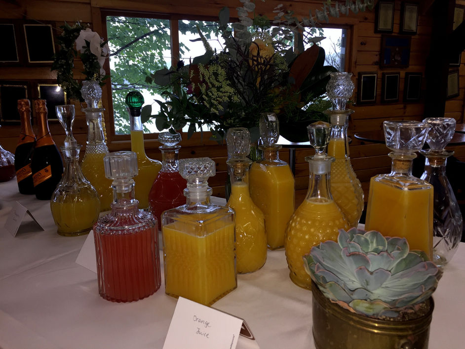Mimosa bar with orange juice decanters and champagne at Camp Lenox