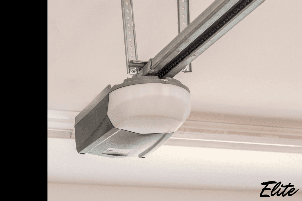 Close-up of a garage door opener motor mounted on the ceiling, highlighting opener features and components.