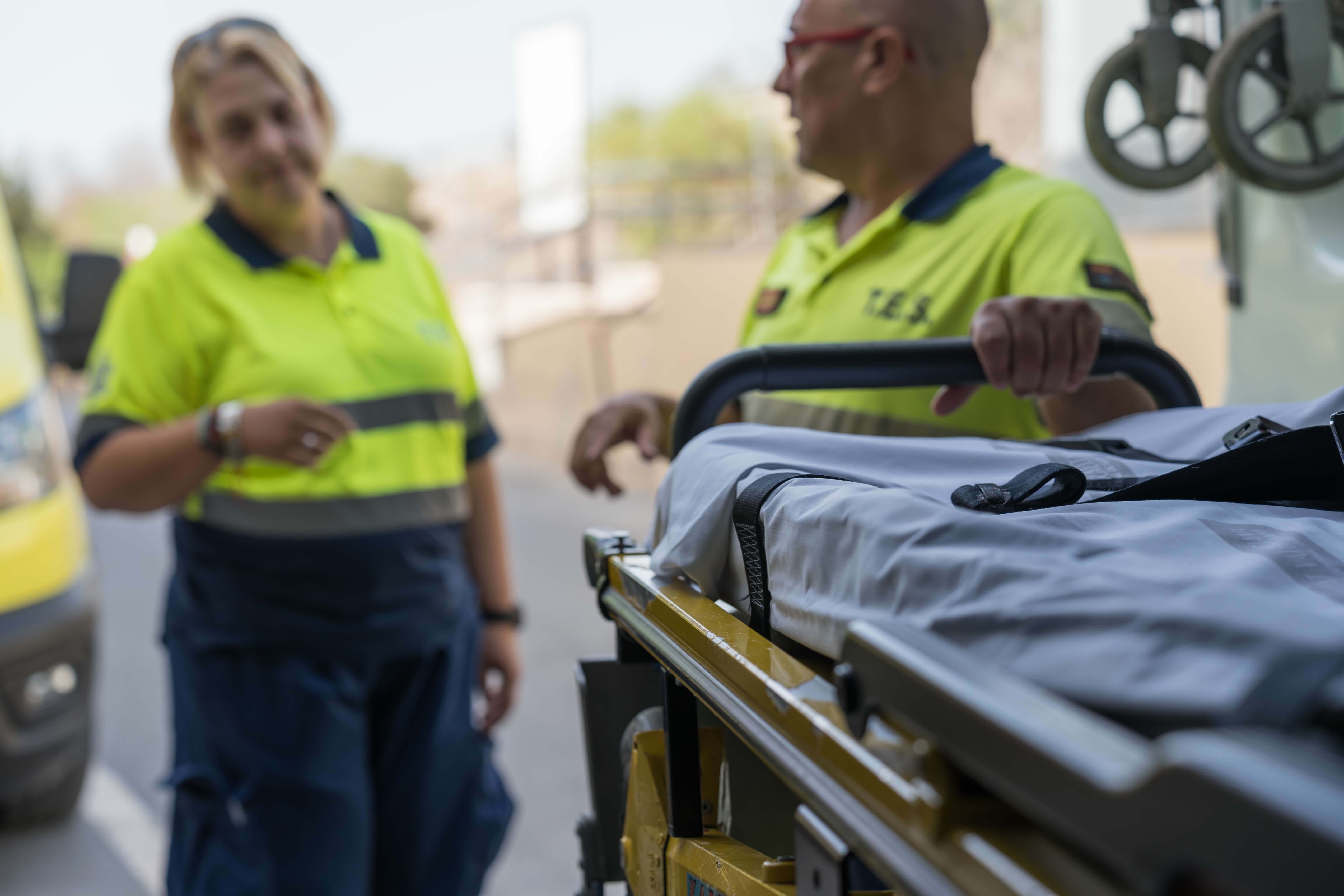 emergency medical team with stretcher and ambulance