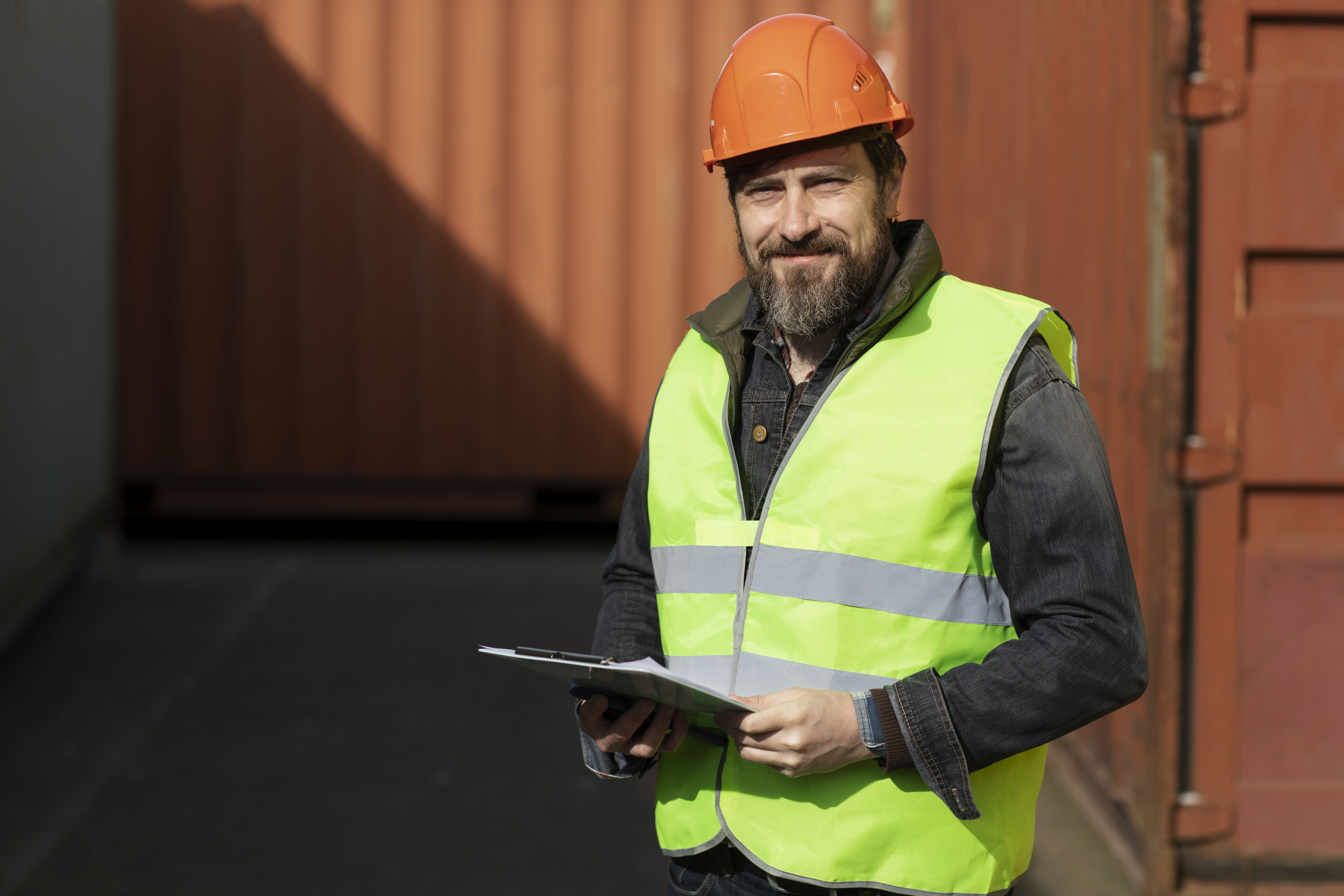 A man wearing a safety vest and helmet