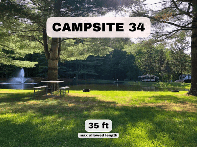 Campsite 34 at Pine Hollow Campground, a 35ft pondfront RV site with a picnic table and scenic fountain views