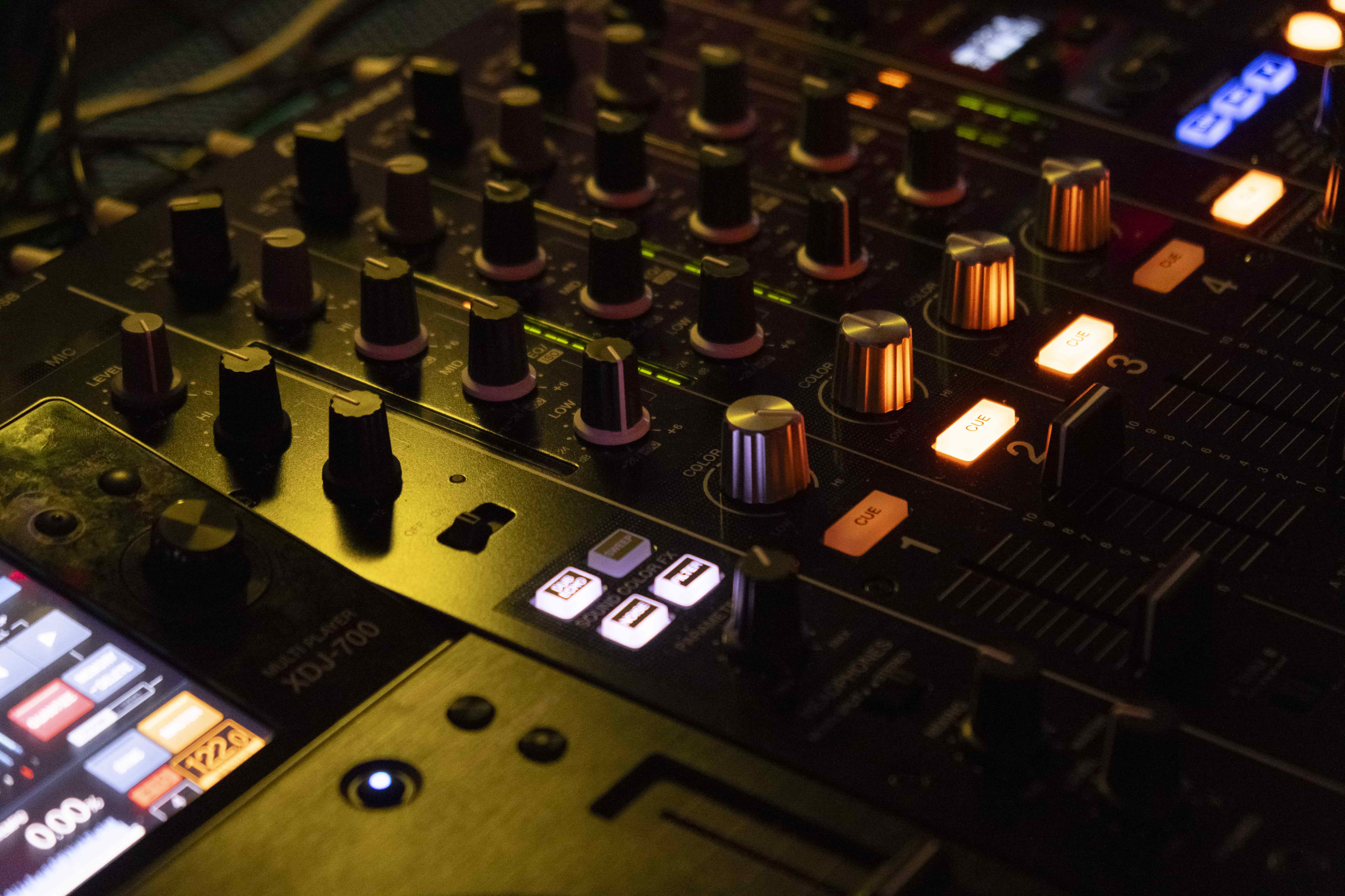 a close up of a mixing board with knobs