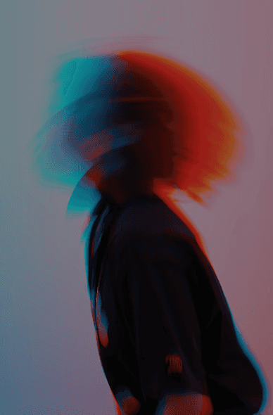 Abstract, motion-blurred portrait of a person in profile with red and blue color overlays against a soft gradient background.”