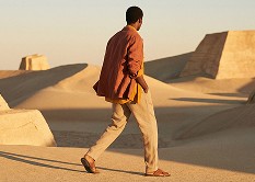 man walking in desert environment