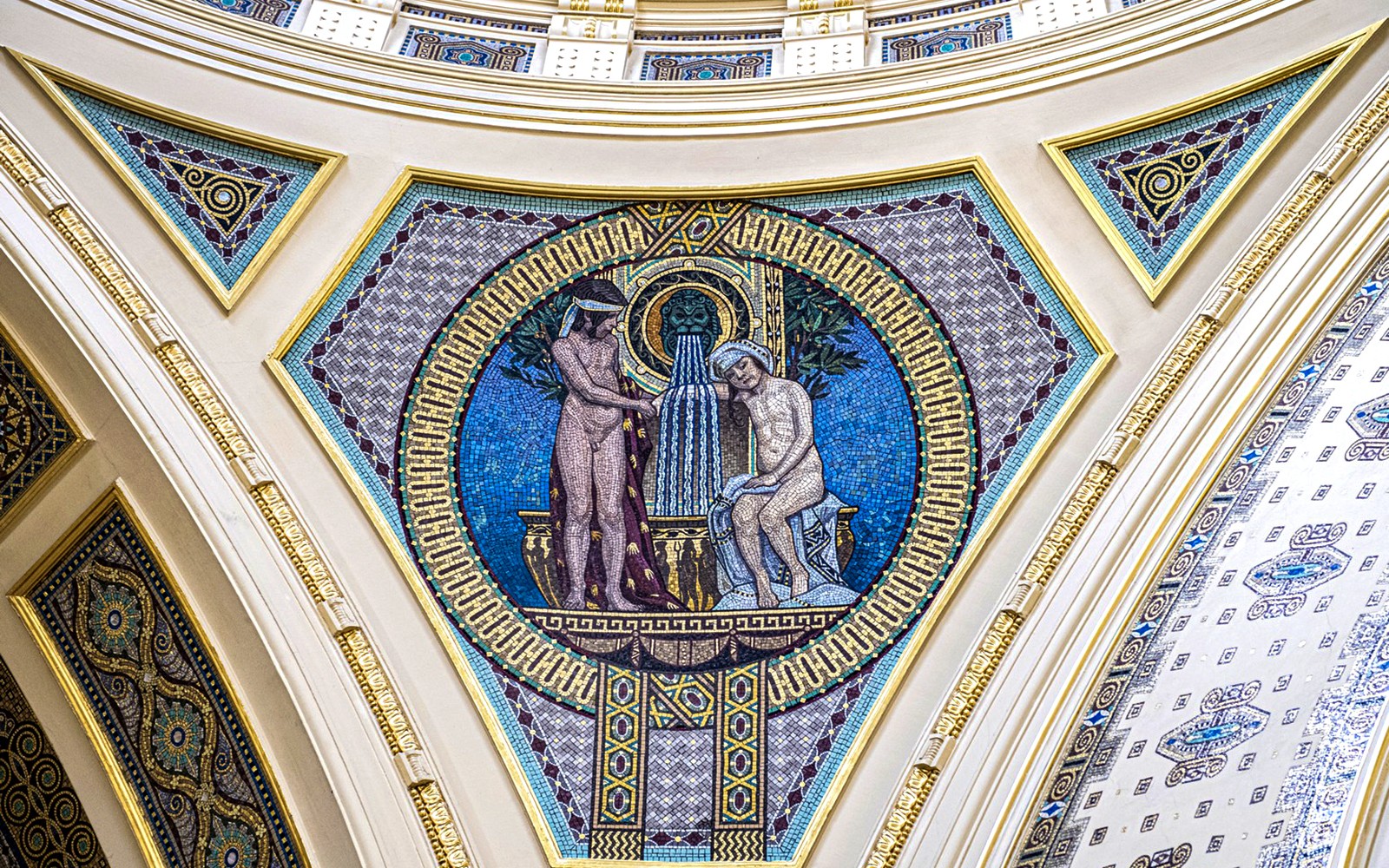 Mósaík listaverk á vegg Széchenyi heilsulindar í Búdapest, sem sýnir klassískar persónur og gosbrunn.