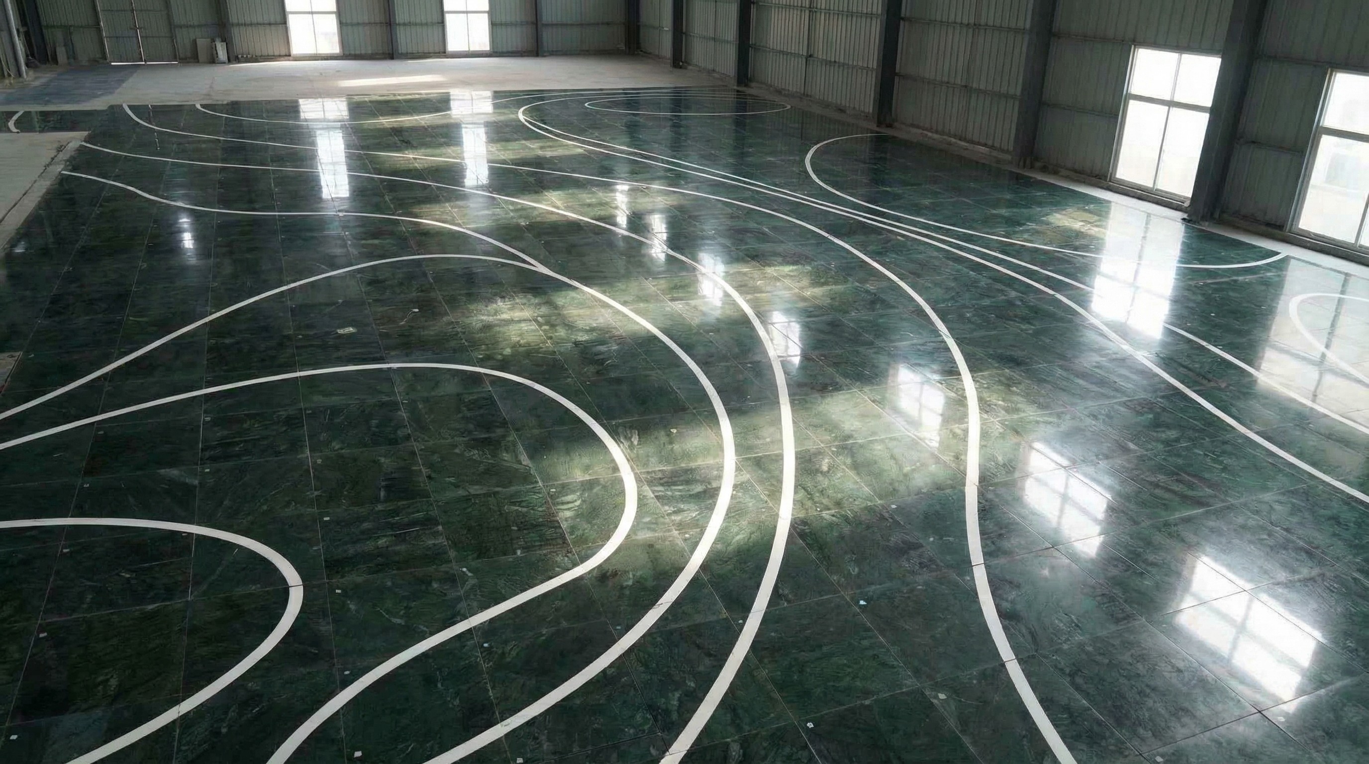 Completed subway station hall featuring futuristic lit-up walls and curved marble floor patterns by NOVA STONE.