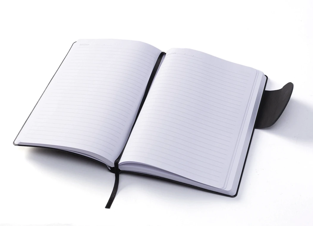 Open journal showing ruled ivory pages and ribbon bookmark