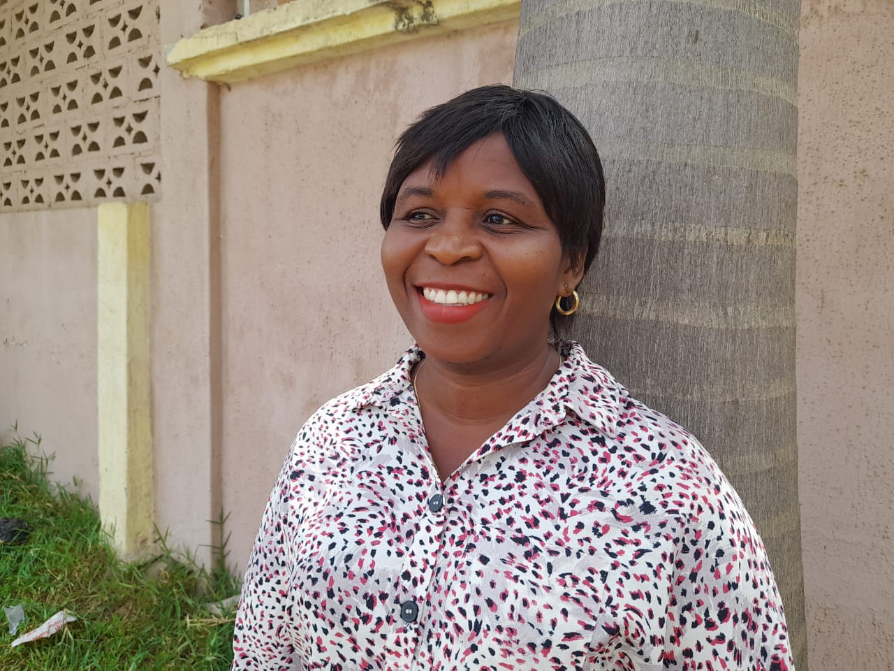 man in black suit jacket holding white ceramic mug