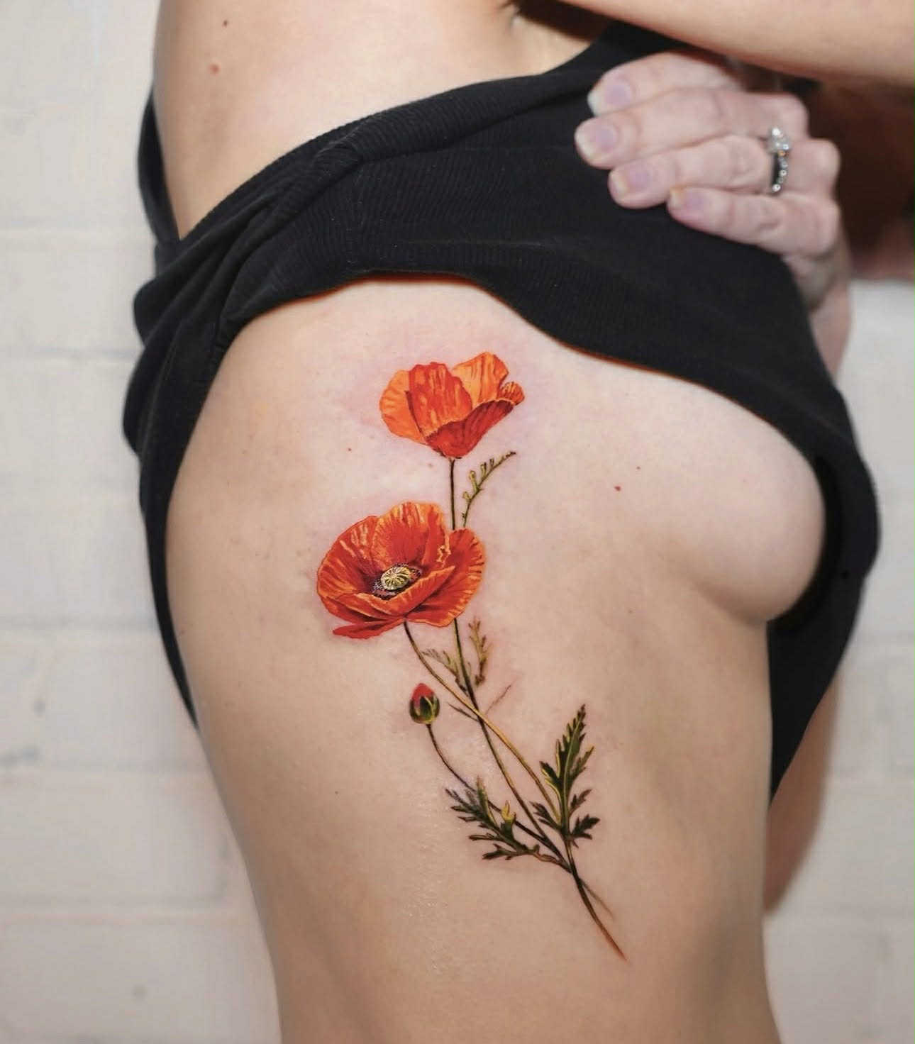 Abstract thigh tattoo of classical bust with geometric lines.