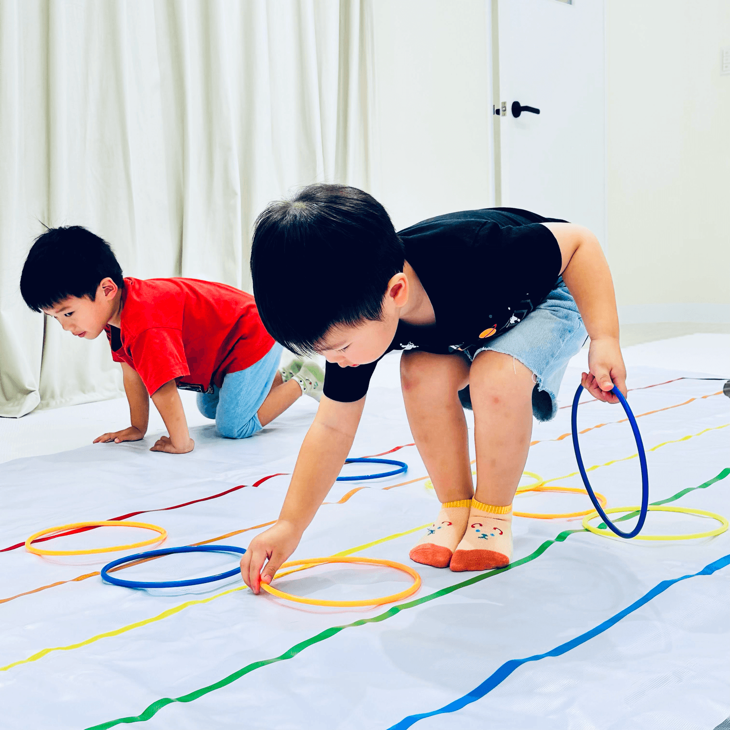 Bright, spacious gallery interior with vaulted white arches, tall windows, and reflective wooden floors