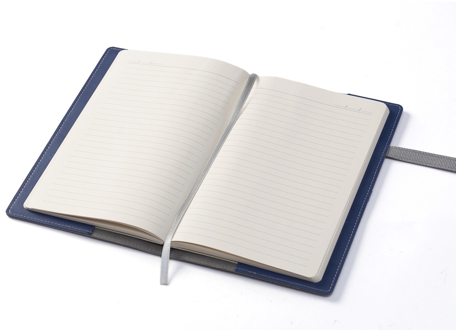 Open notebook displaying lined pages and silver ribbon bookmark.