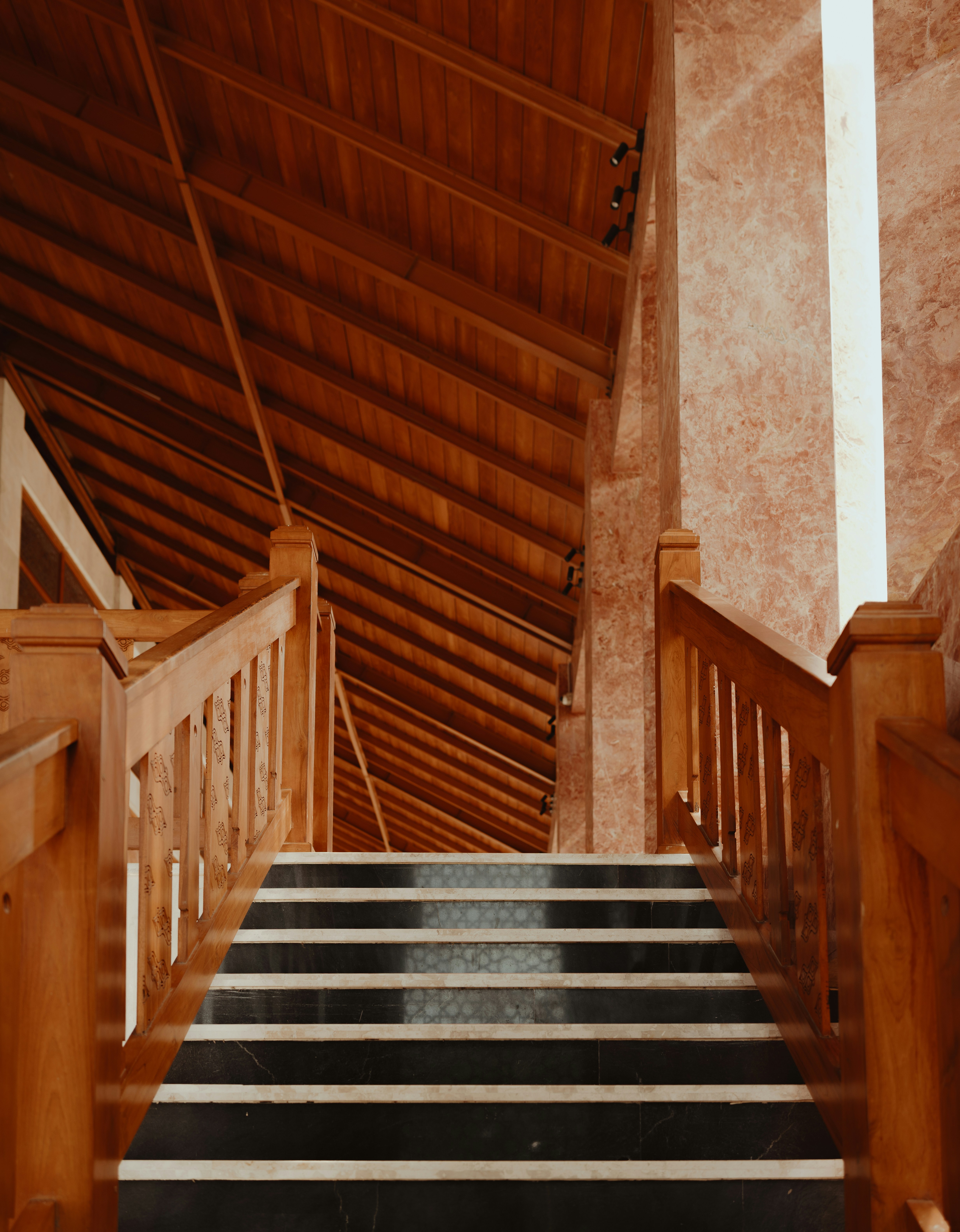 Stairway leads up to a wooden ceiling.