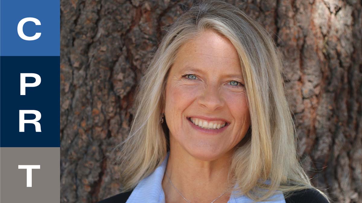 A smiling woman with blonde hair stands in front of a tree, with "C P R T" text on the left.