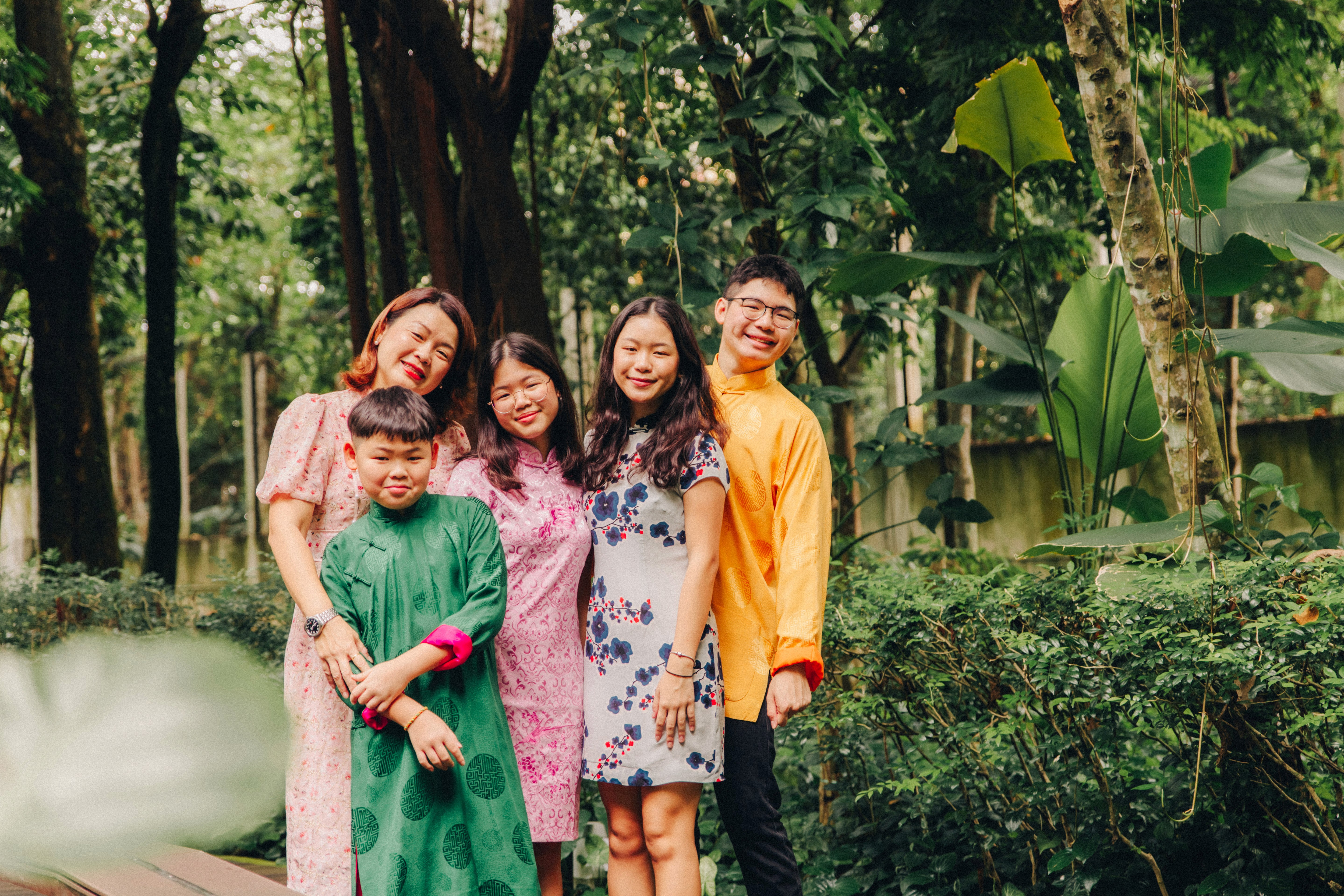 Quan jia fu (full family photo) in traditional cheongsams and outfits for Chinese New Year at Singapore Botanic Gardens.
