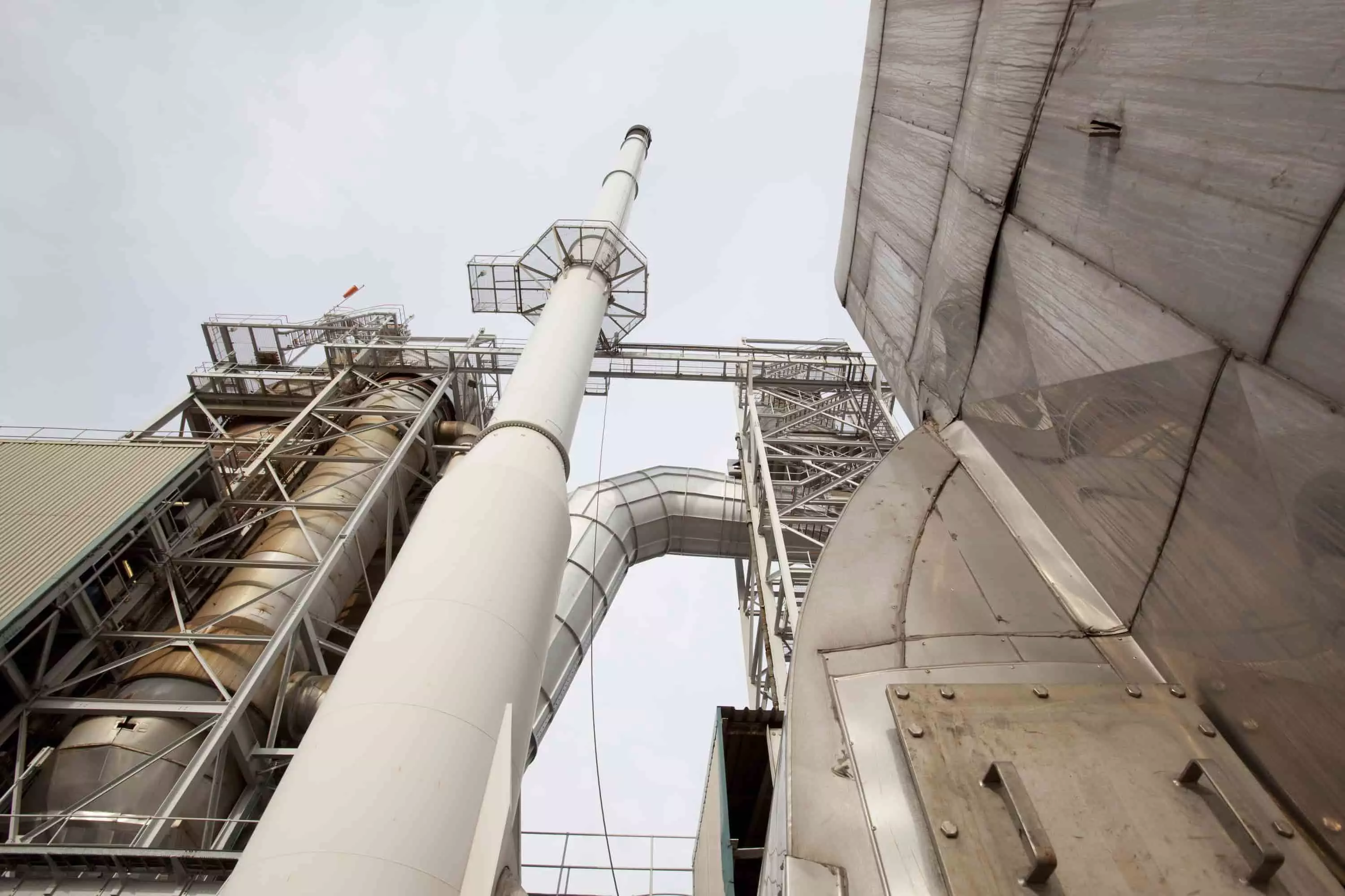Industrial pipework and silos viewed from below at an Ellesmere Port facility.