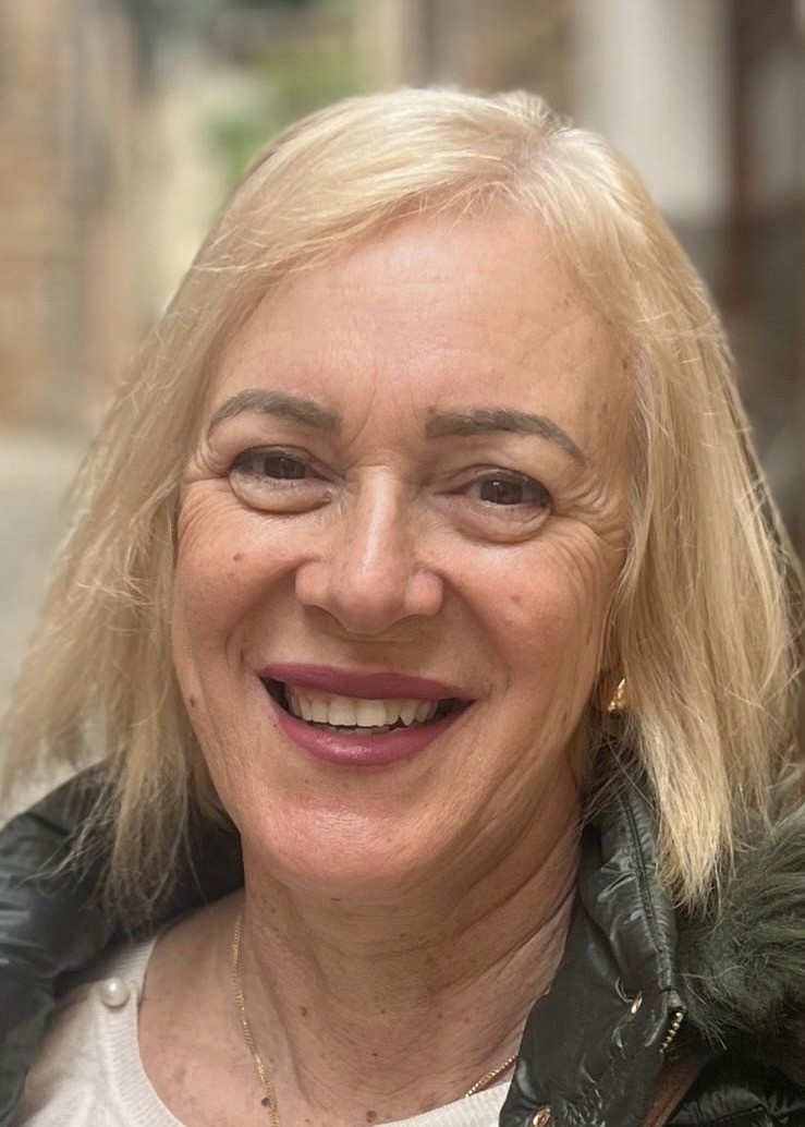 Sara is a client smiling to the camera happily