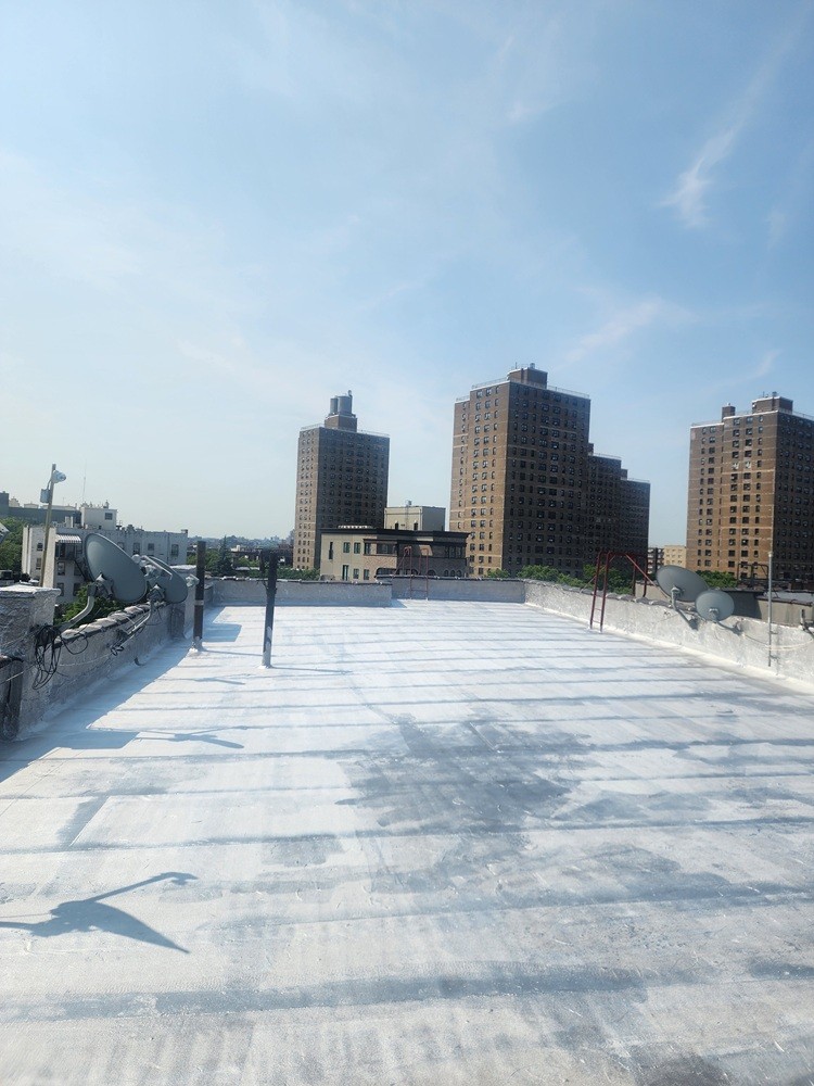 after complete roof replacement with new 3/4 plywood, felt paper, App-160 rubber roof membrane and applying 2 coats of silver coating by Jewel Construction in Brooklyn Heights
