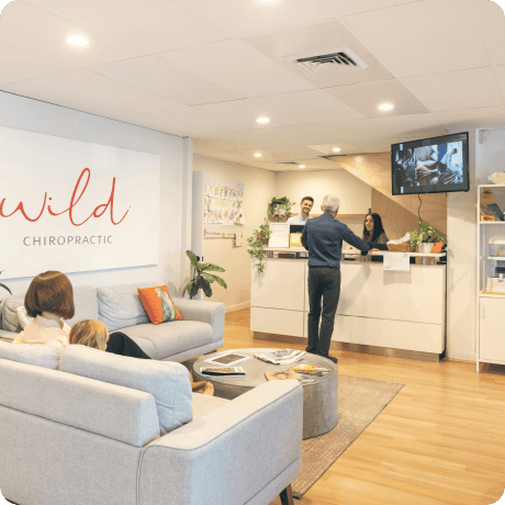 Sofas, plants and reception desk inside Wild Chiropractic