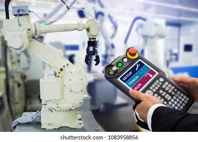 Engineer teaching a robot pendant
