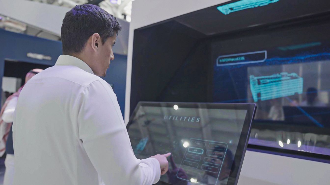 emirati man using a touchscreen at a KAFD event