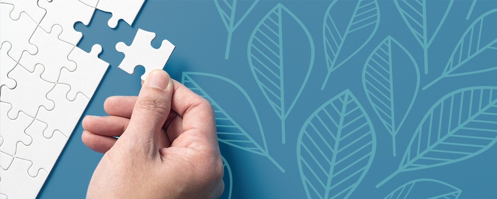 Hand fitting a puzzle piece together
