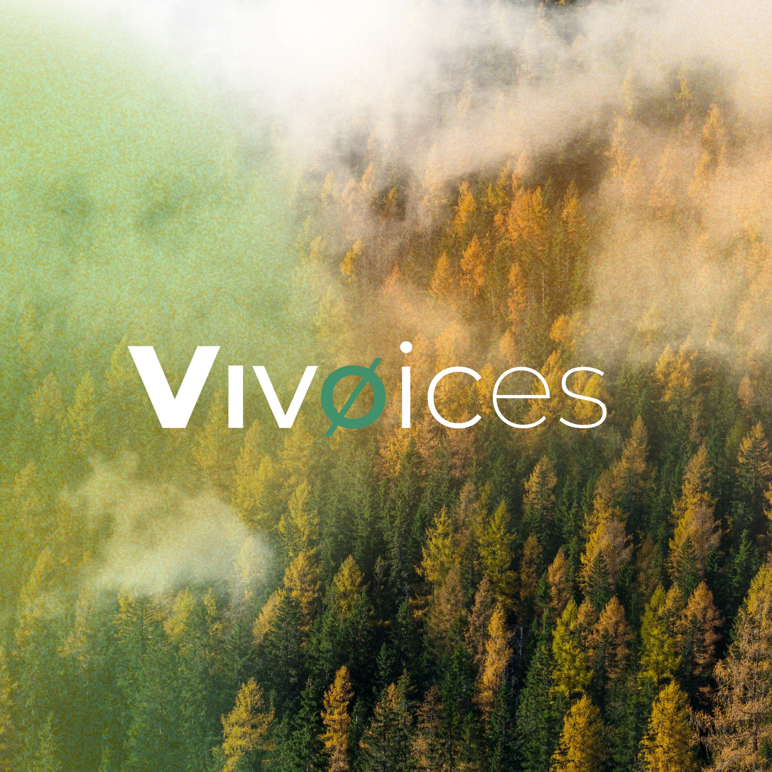 A young person with curly hair smiles at the camera while sitting in front of a laptop against a dark background.