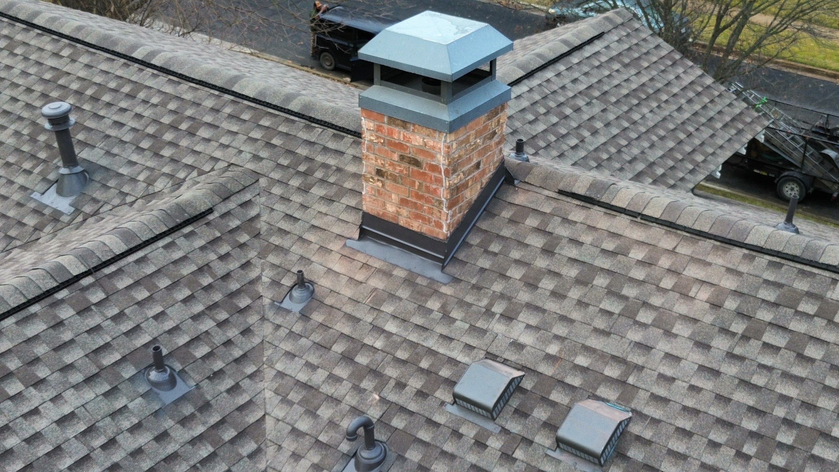 Close-up of the chimney with new step and counter flashing tied into the new GAF Armorshield II shingle field