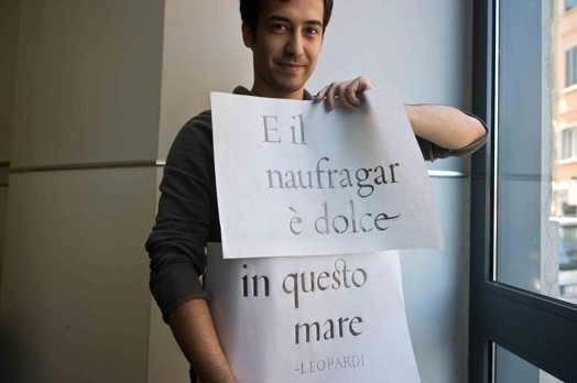 man holding two papers