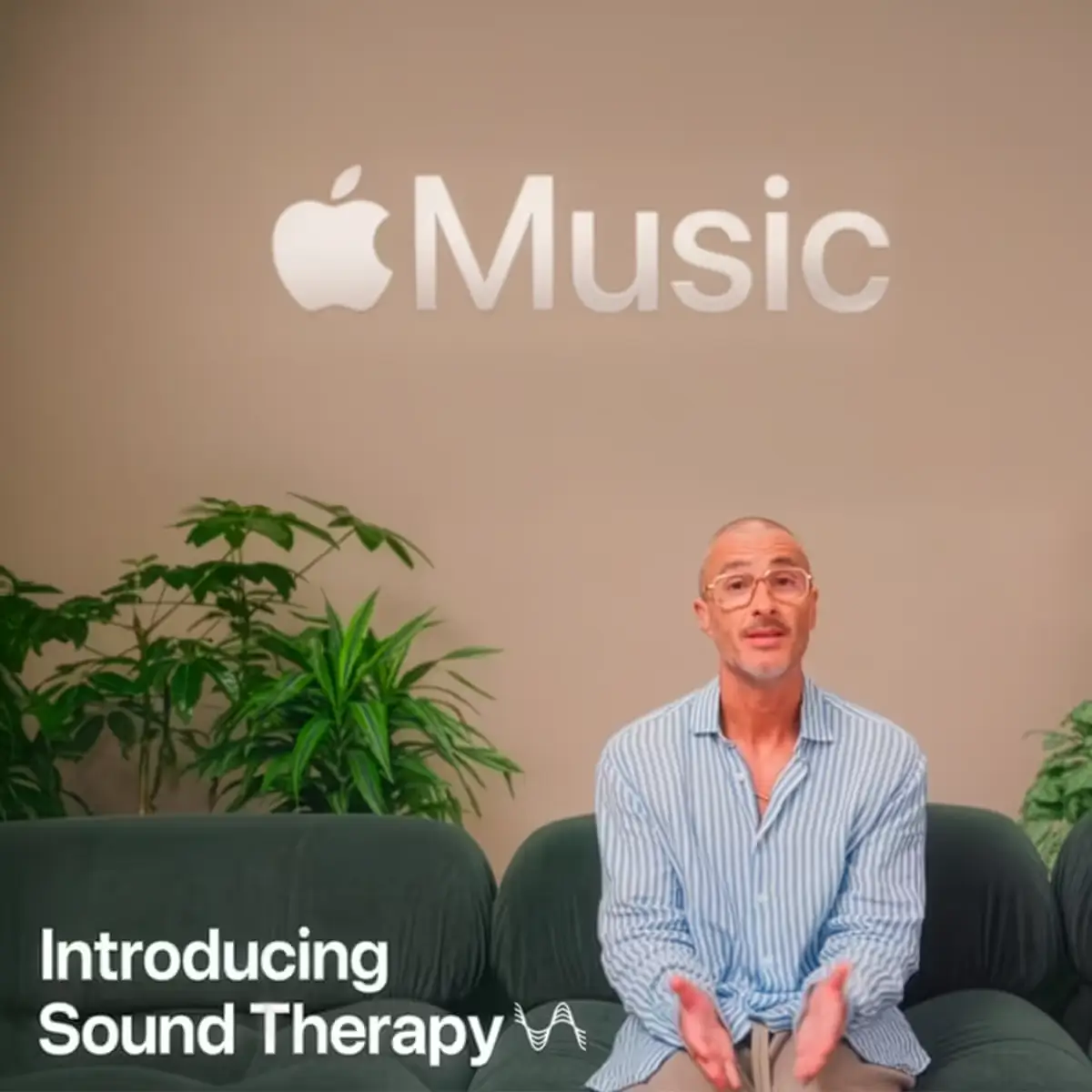 Apple Music studio shot with a presenter seated on a sofa and on-screen text reading “Introducing Sound Therapy.”