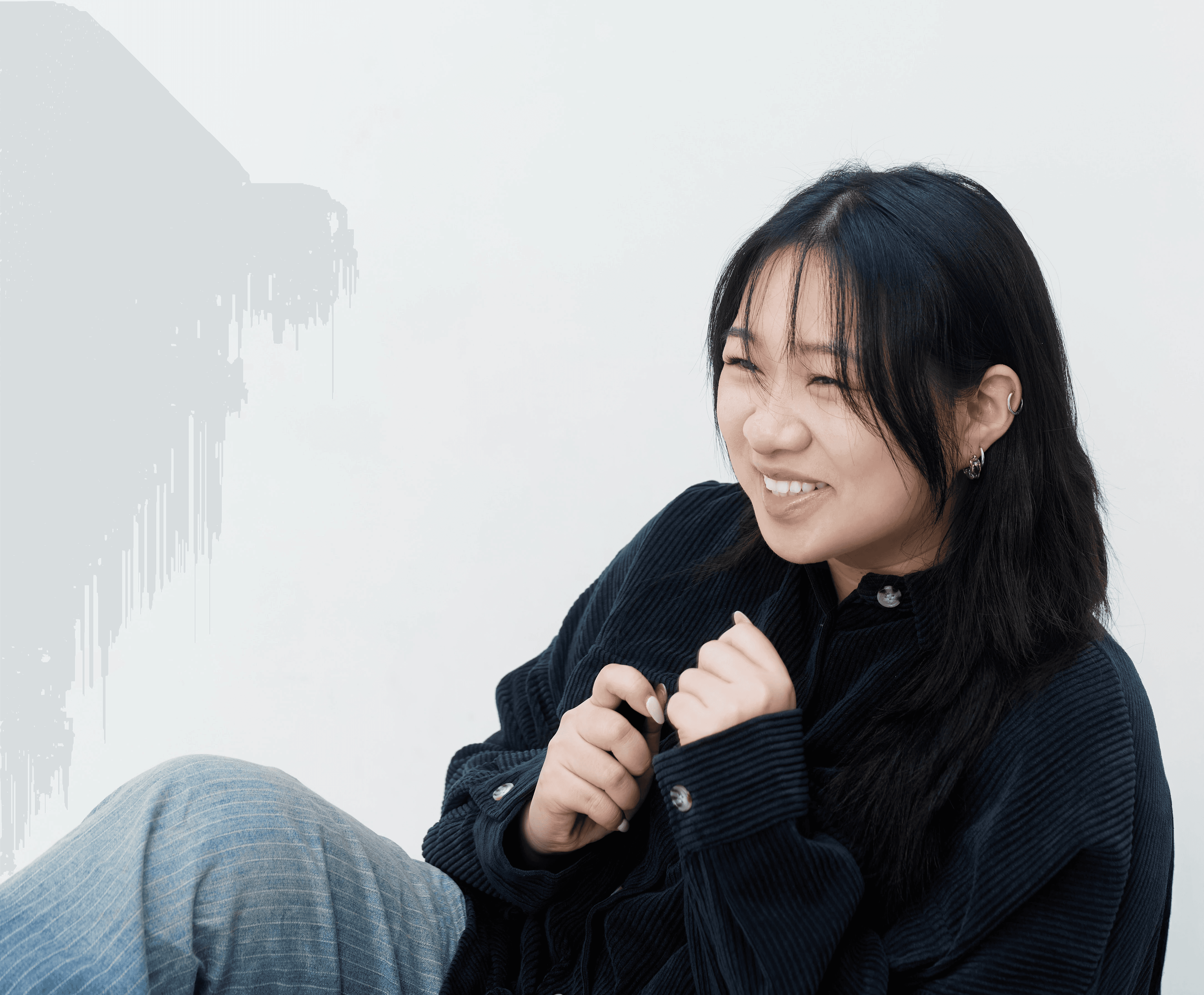 A group of four people engaged in a discussion while seated in a cozy, plant-filled setting.