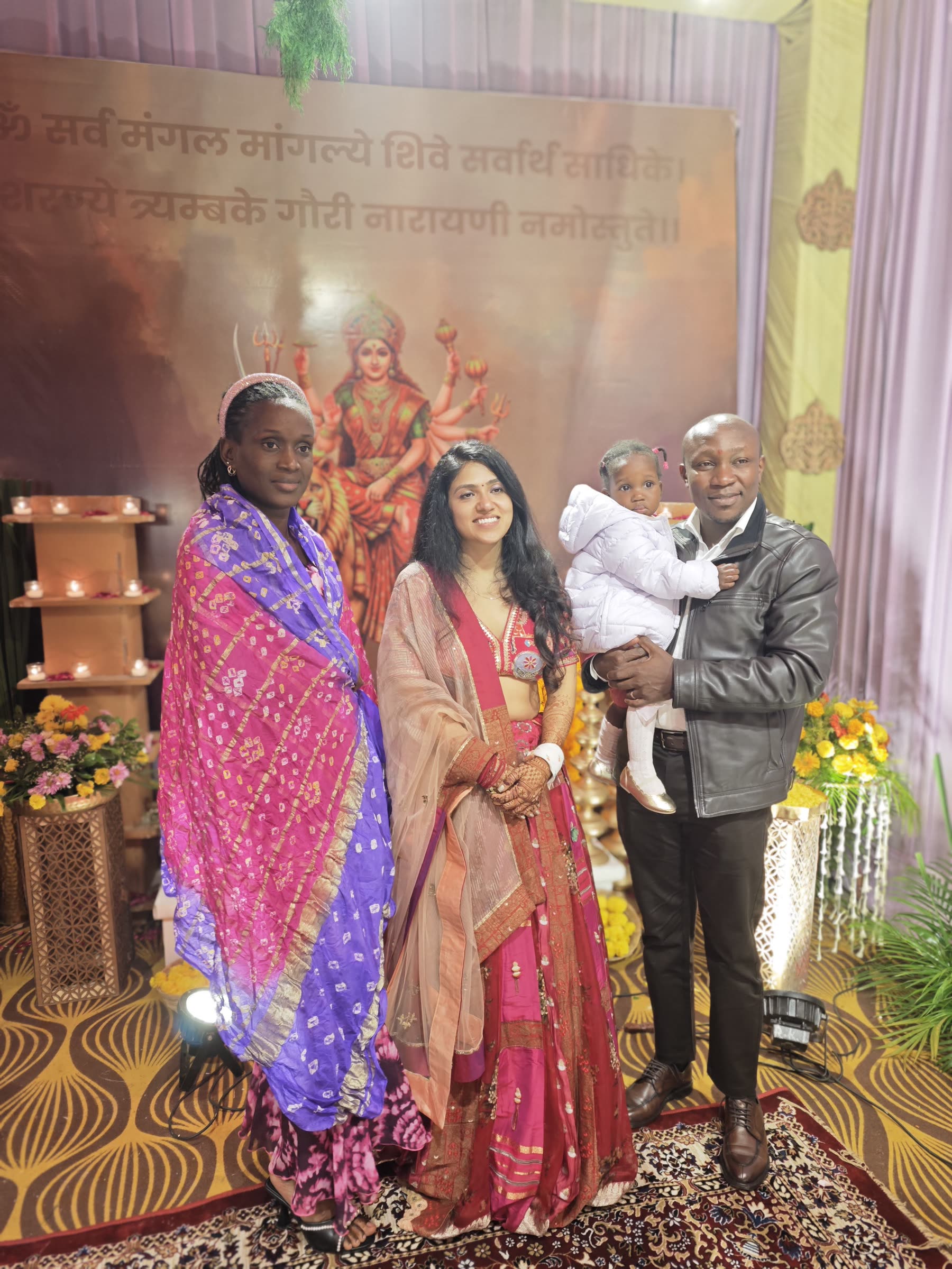 Family standing before a ceremonial backdrop