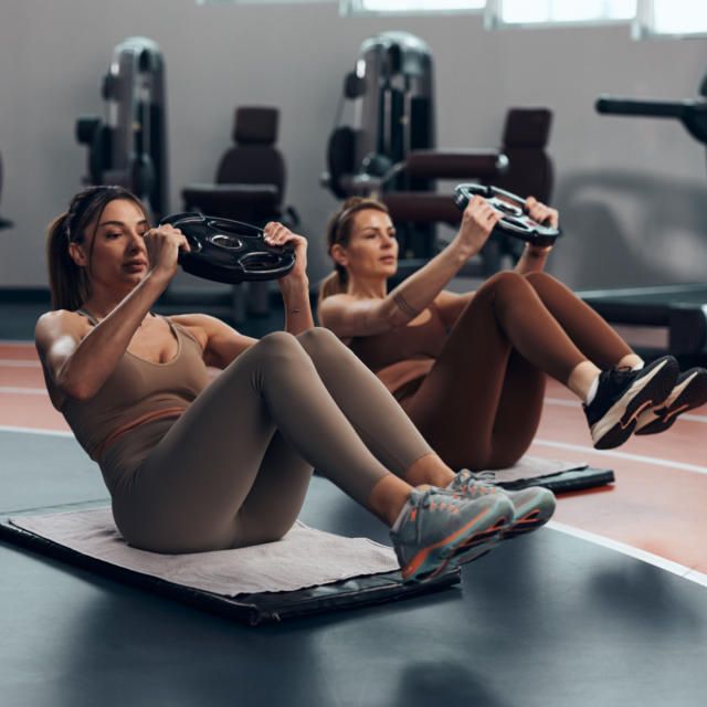 A wooden essential oil diffuser releasing a gentle stream of steam, surrounded by dried herbs and a small bottle of essential oil. The warm lighting enhances the cozy and therapeutic ambiance.