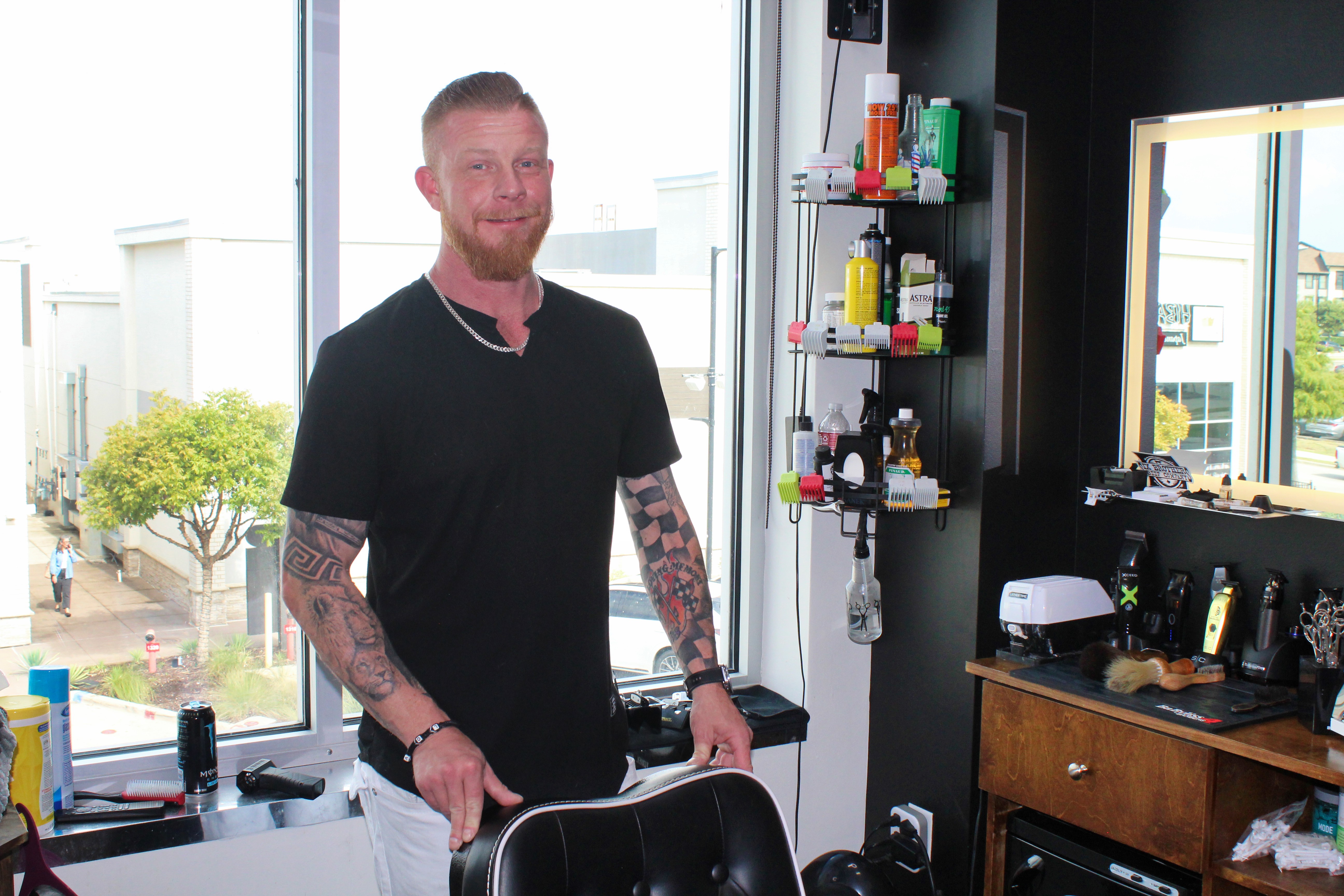 Matt Finner, Master Barber at Minnesota Matt’s Barbershop in Euless, TX, standing in his bright, modern barber suite. A top-rated barber with over a decade of experience, specializing in fades, beard trims, and no-fuss service.