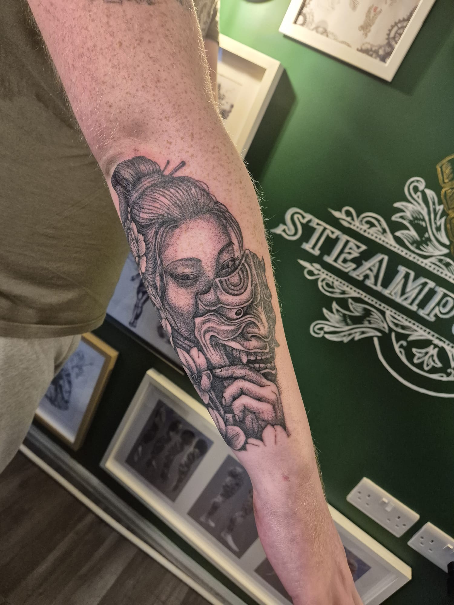 Black and grey tattoo sleeve with skulls and ornamental patterns