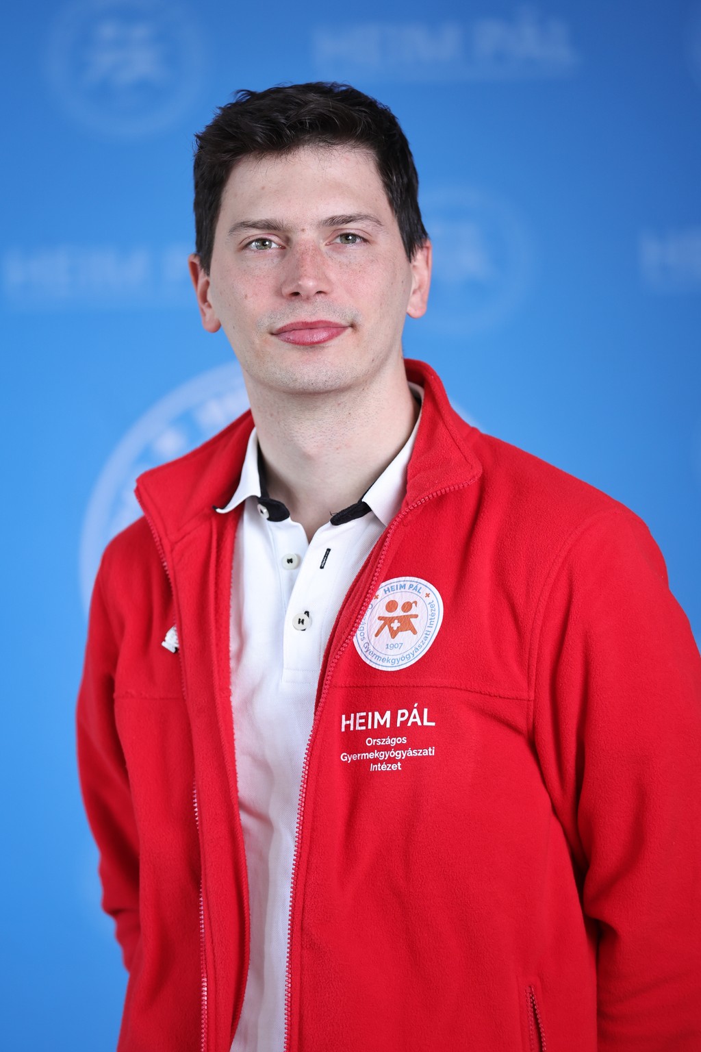 Rövidhajú férfi piros kardigánban