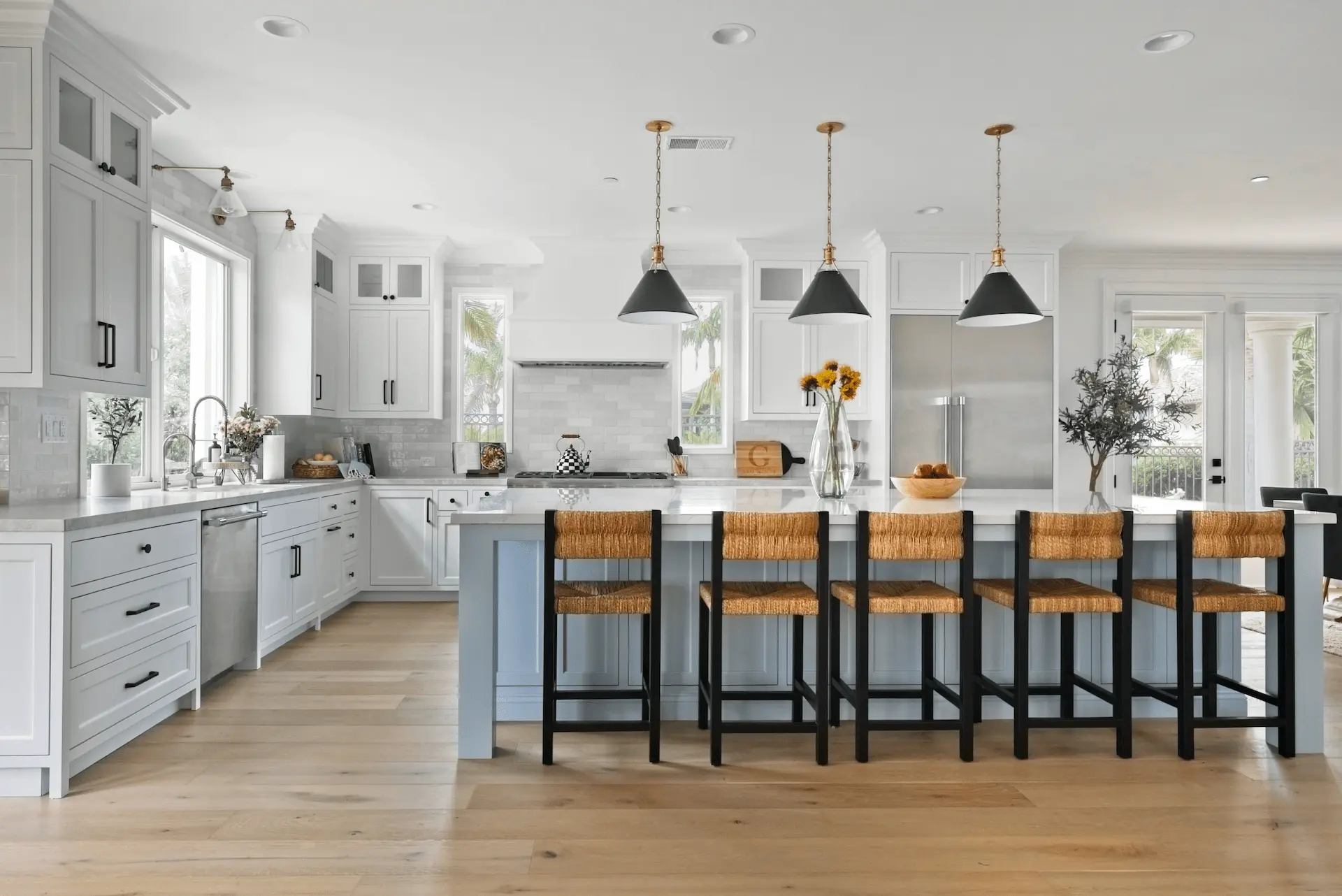 Wide shot capturing the entire kitchen layout with a focus on the stove area in the Dana Point Remodel. Photo by Todd Huge.