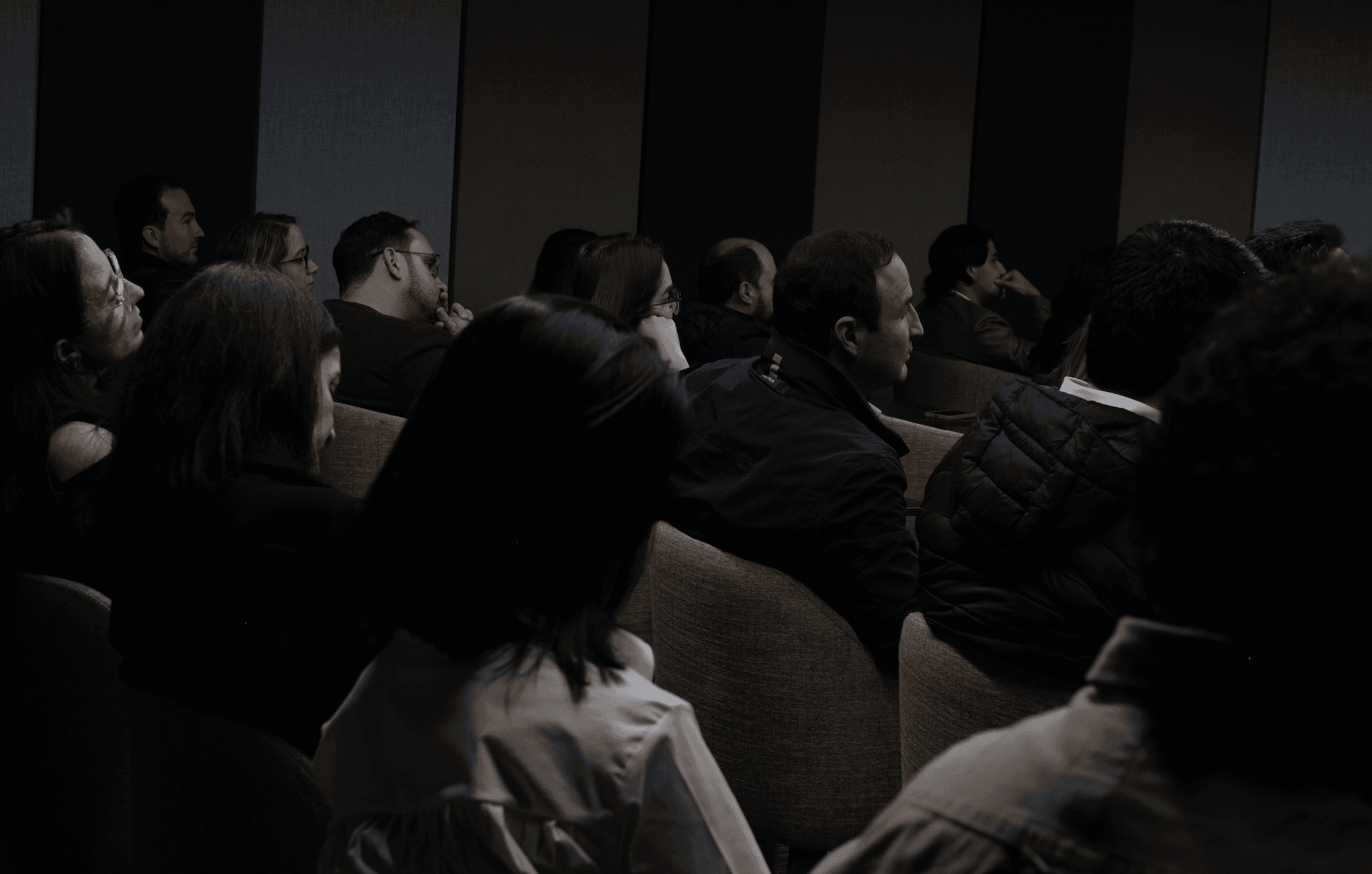 Tree branches reach towards a clear, blue sky.