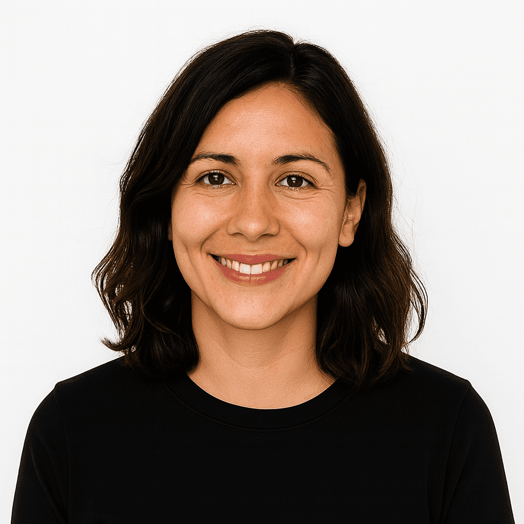 Woman with shoulder-length wavy hair wearing a black top.
