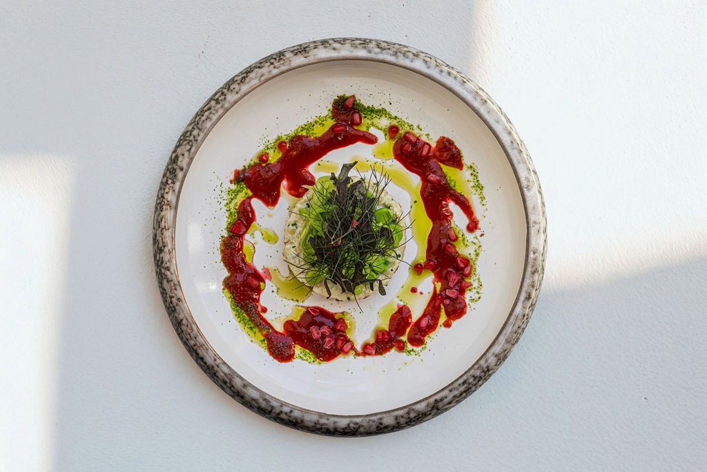 creative fish dish with sauce and vegetables