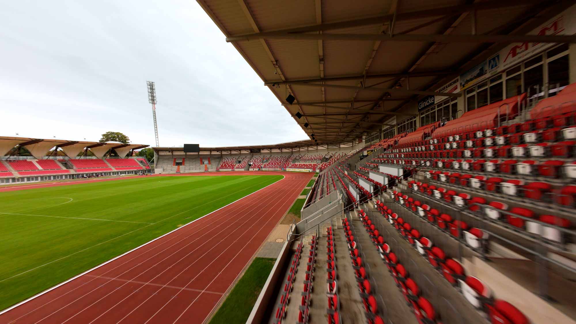 Empty stadium seats and track, perfect for filmproduction and strategic filmcampaigns capturing brand stories.